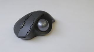 The mouse's thumb buttons are located to the right of the trackball.