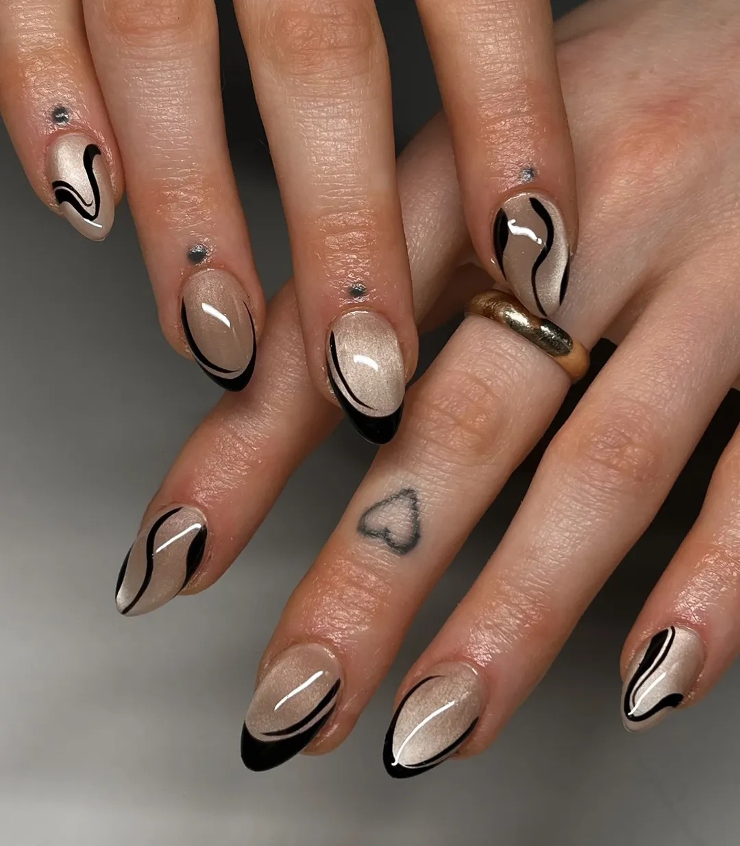 a cat eye manicure with black designs