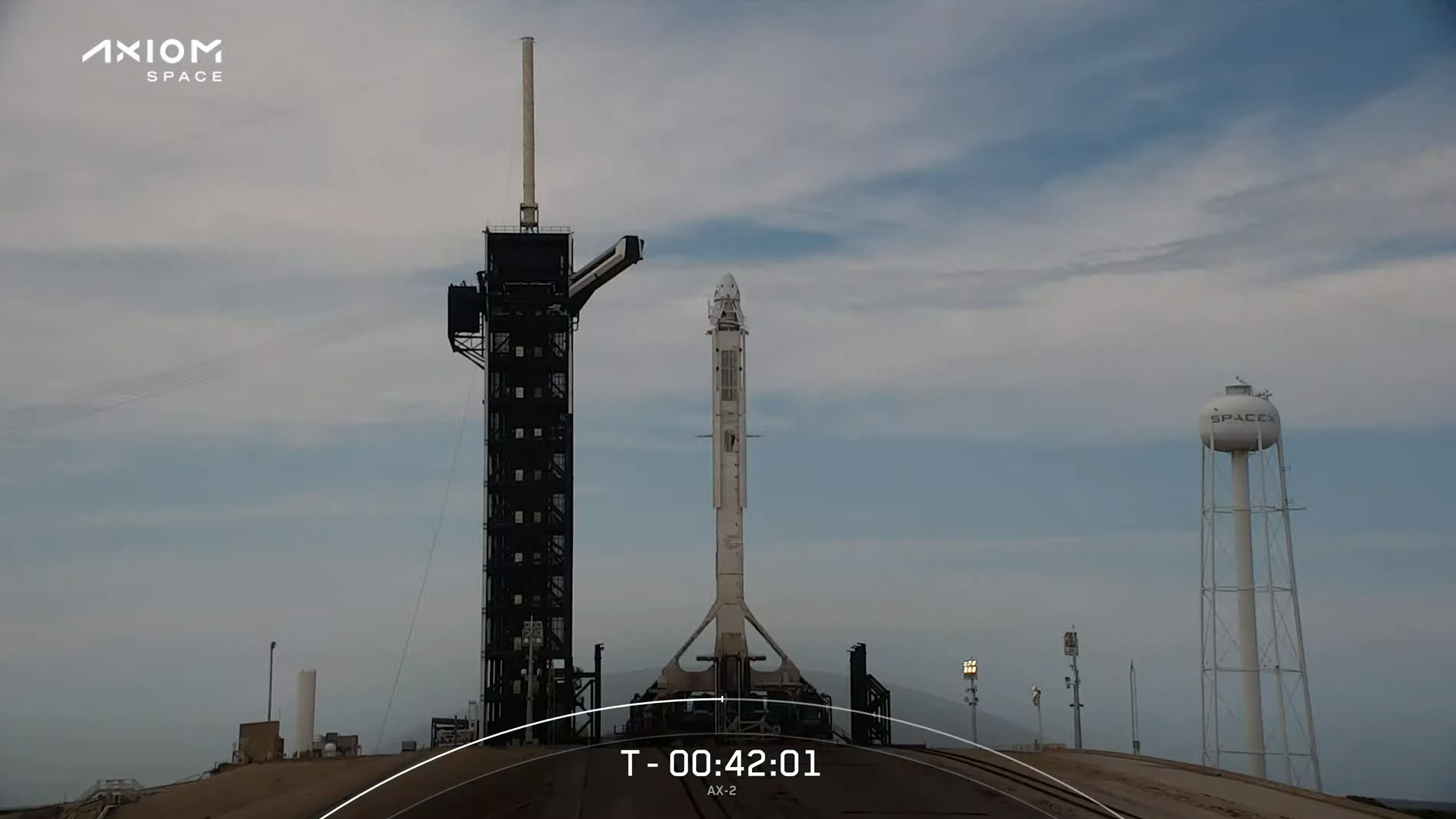 White SpaceX rocket on launch pad with crew access gantry retracted