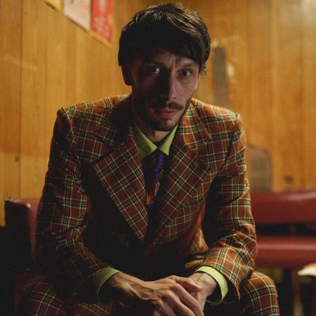 Richard Gadd as Donny Dunn, sitting at a wood-paneled restaurant booth, in 'Baby Reindeer'