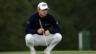Patrick Cantlay lines up a putt during The Masters