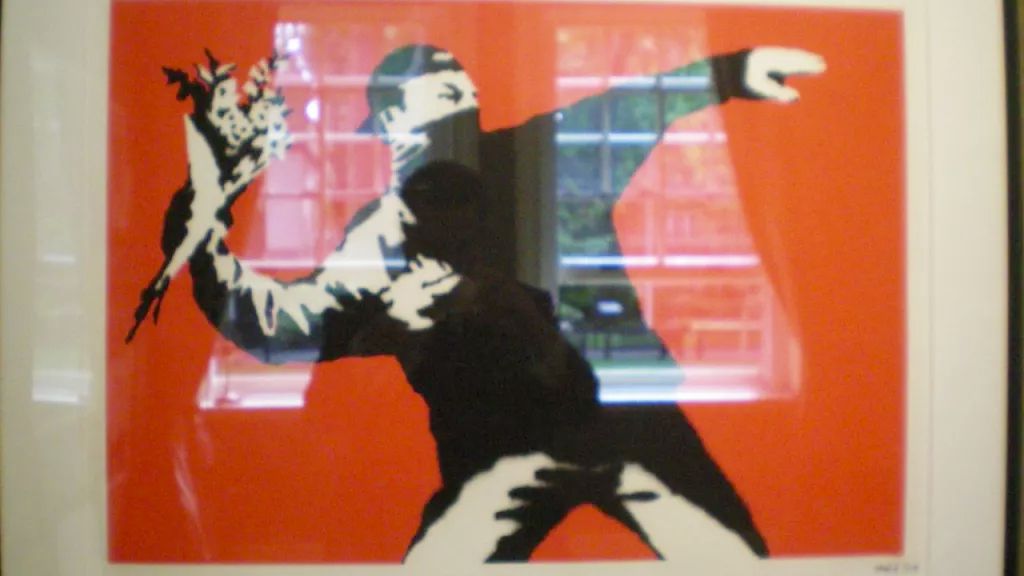 Banksy artwork of man throwing flowers