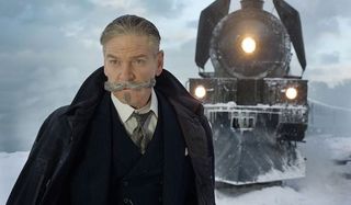 Murder on the Orient Express Hercule Poirot posing in front of the train