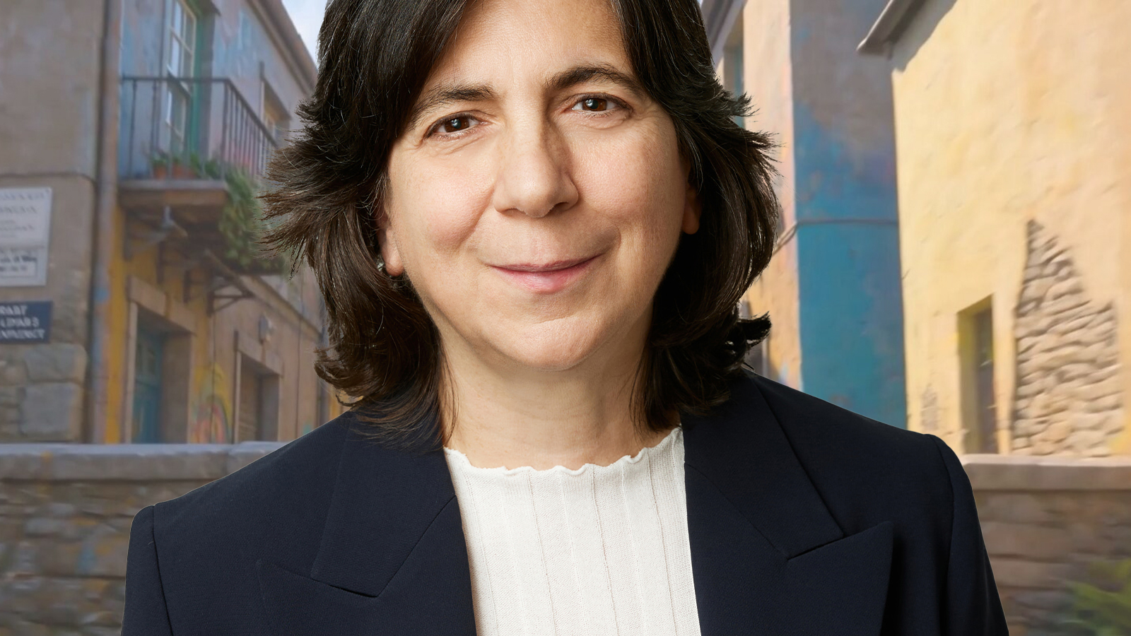 A woman in a business suit smiles