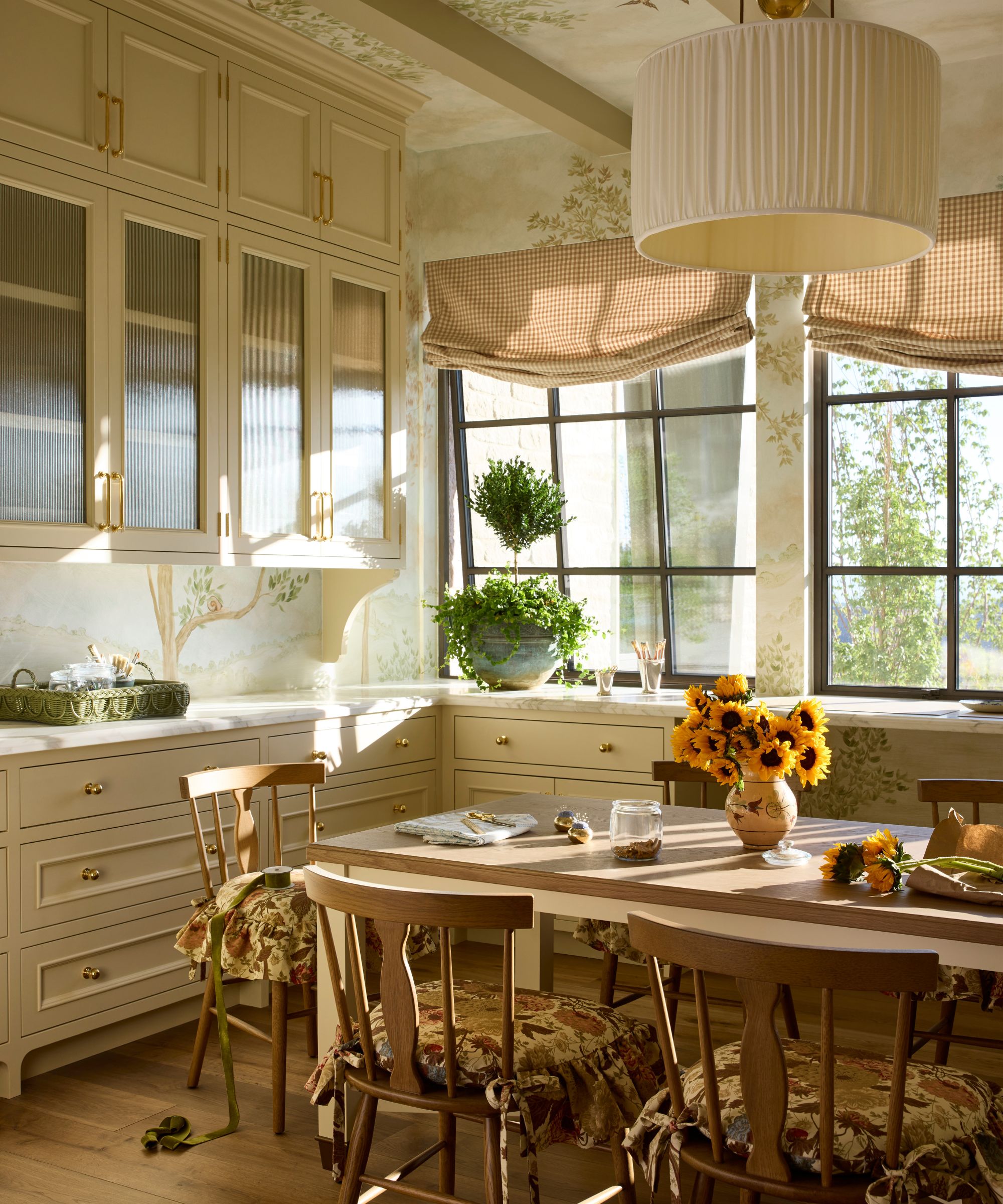 a neutral cottage-style craft room in a utah family home with cabinetry, painted ceiling, wooden table and gingham blinds