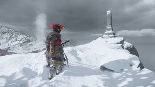 Atsu standing in front of a Pillar of the Fallen on a snowy outcropping