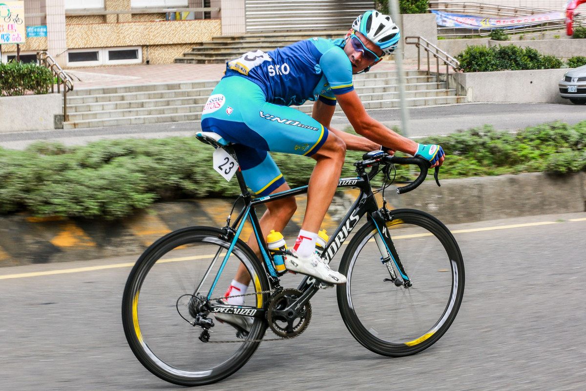 Stefan Astafyev (Vino4Ever) checks his gap over the peloton