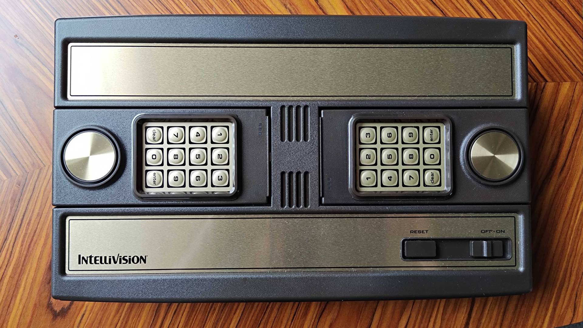 Top view of Intellivision Sprint on woodgrain table.