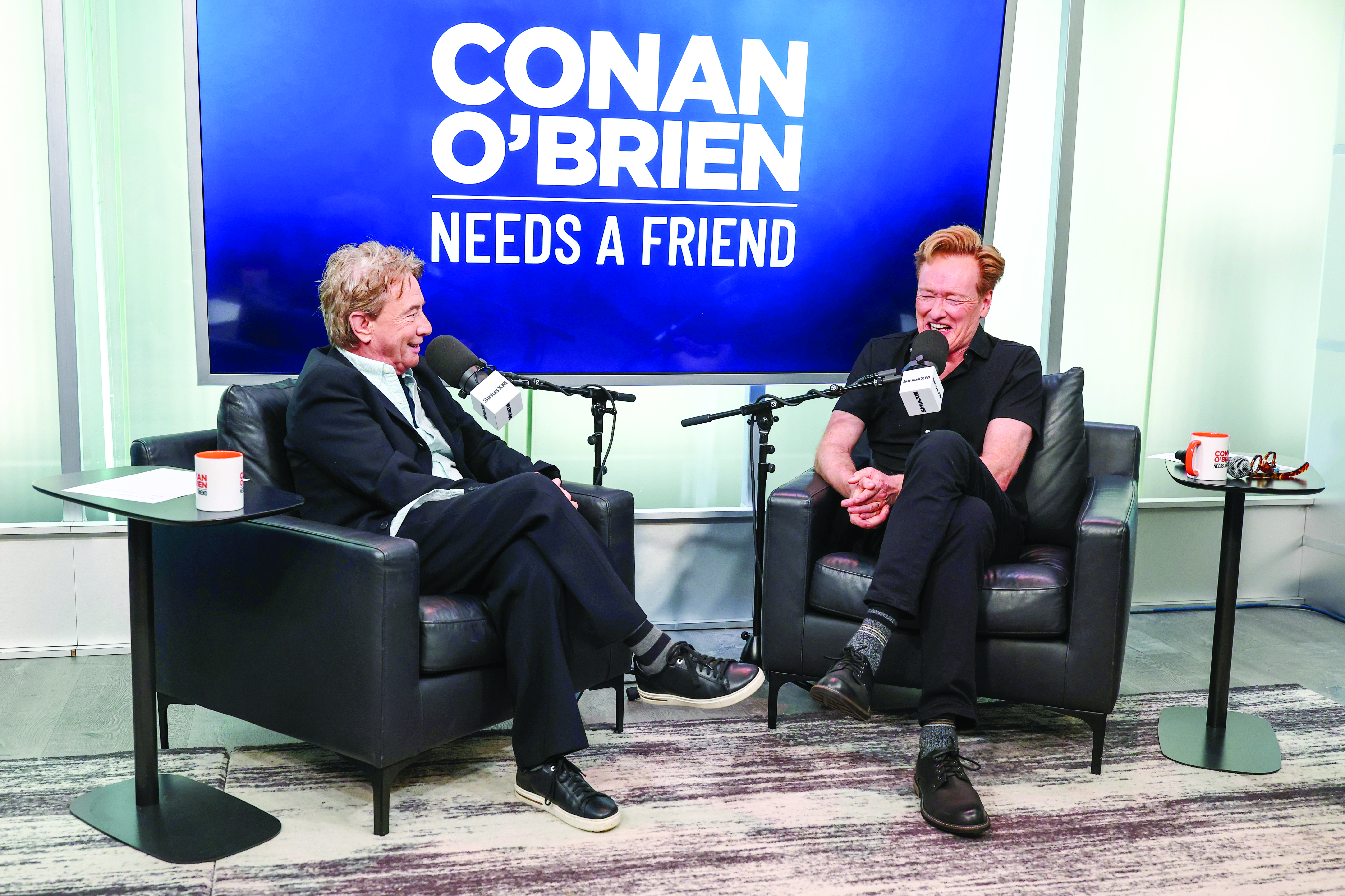 Conan O&rsquo;Brien, shown at right with guest Martin Short, says his podcast has a wider reach than his late-night TV shows did.