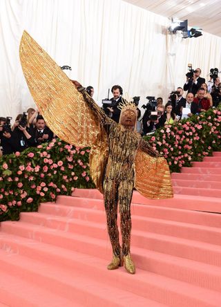 Billy porter with golden wings at the MET gala