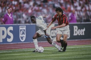 AC Milan's Paolo Maldini challenges Marseille's Abedi Pele in the 1993 Champions League final.