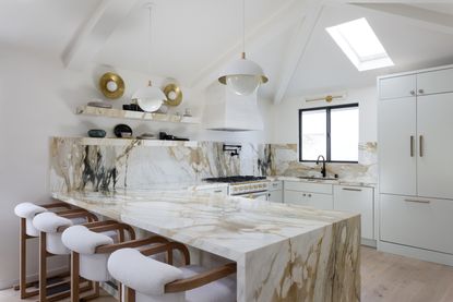 a marble kitchen with open shelving