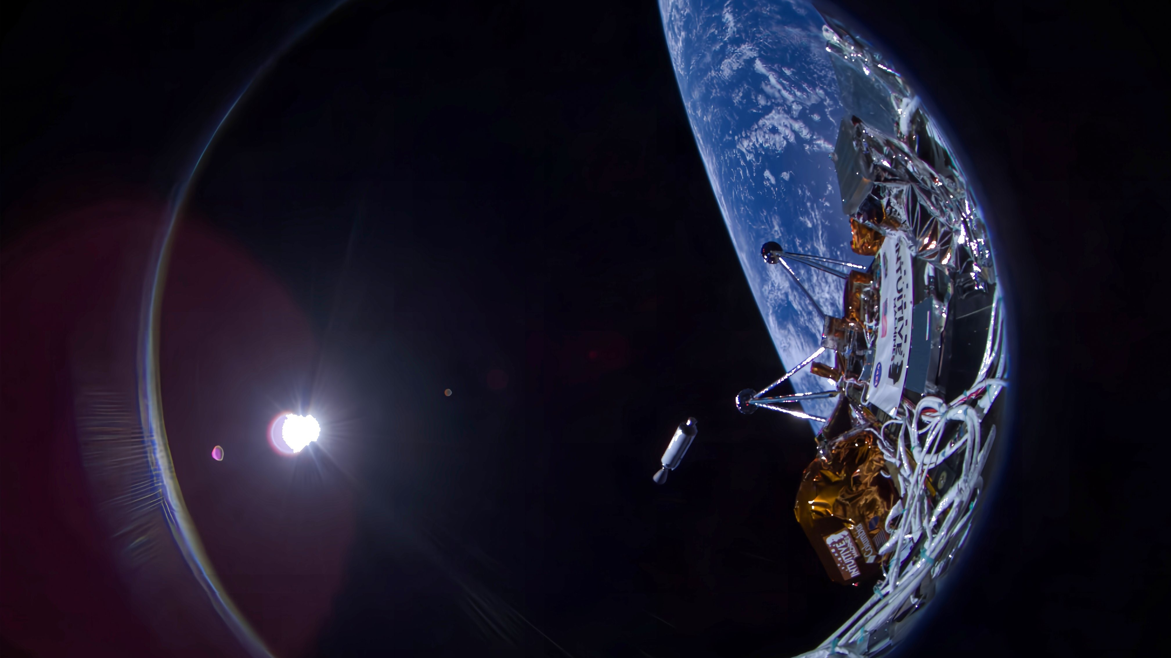 closeup of a spacecraft selfie showing gray and gold-wrapped components, with the curve of earth and the distant sun in the background.