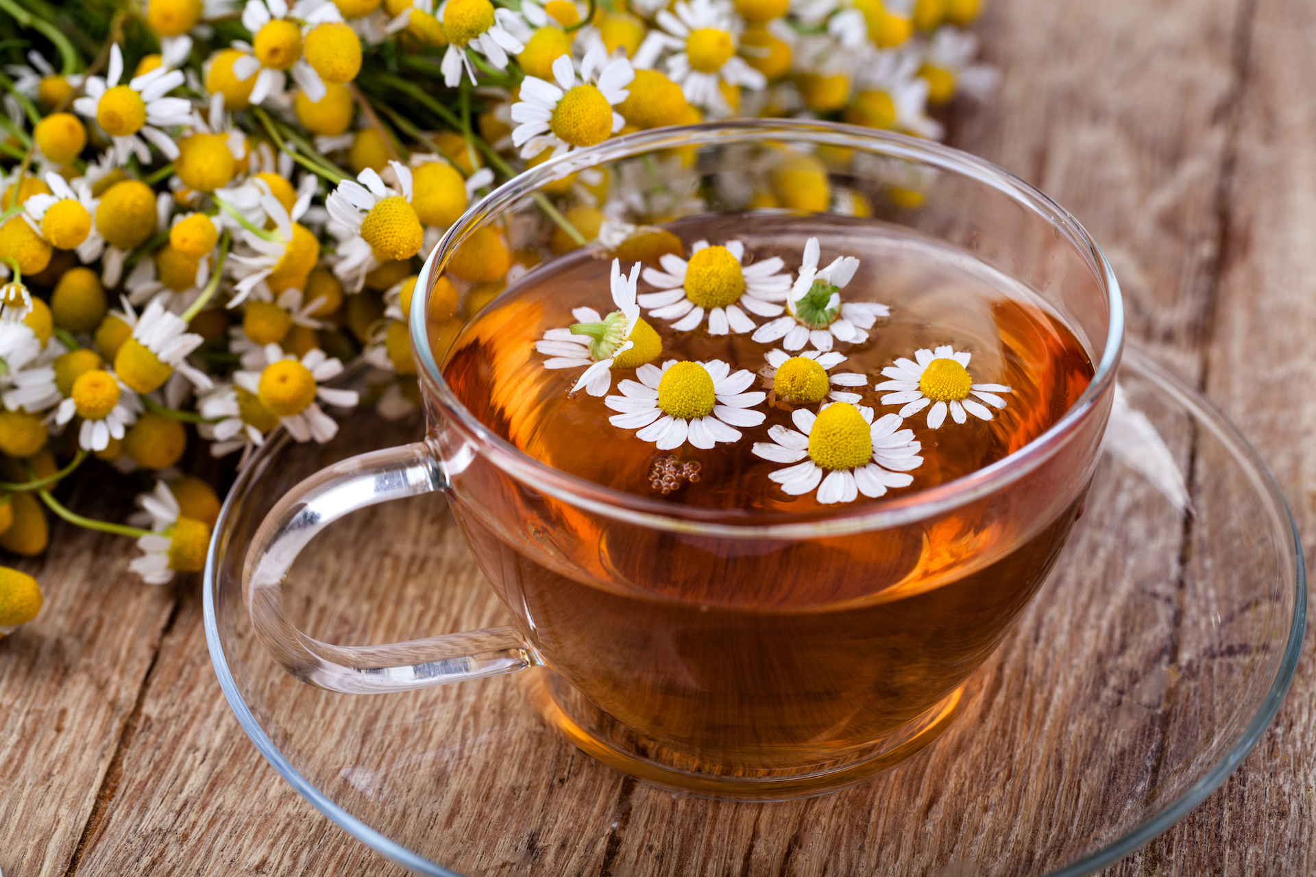 Cup of chamomile tea and flowers