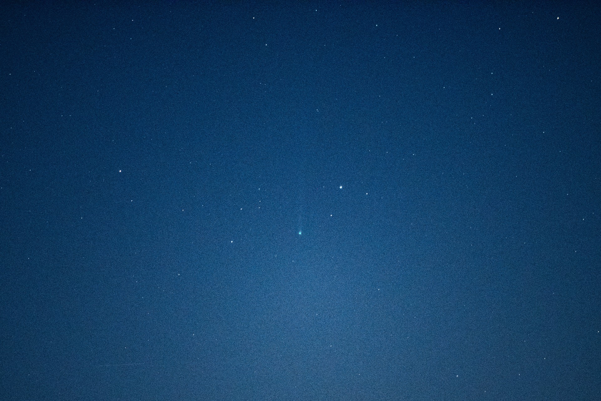 a fuzzy green dot in the night sky