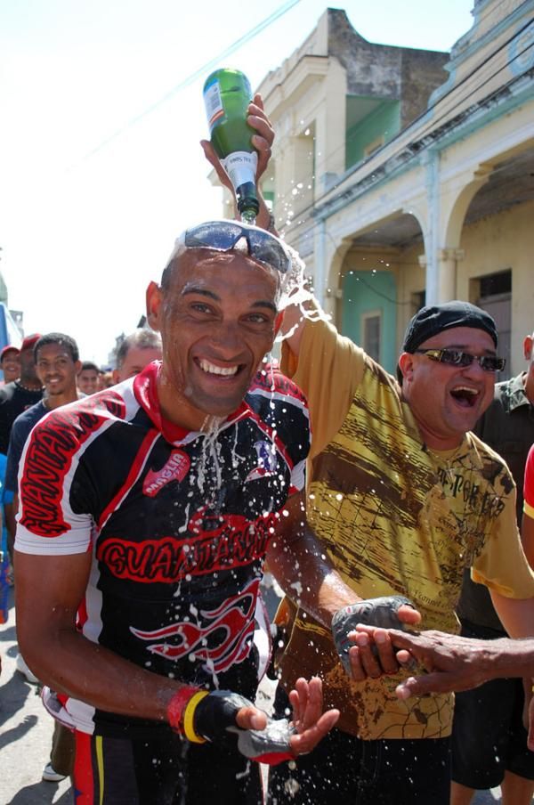 Damian Martinez celebrates his third place finish with a champagne shower