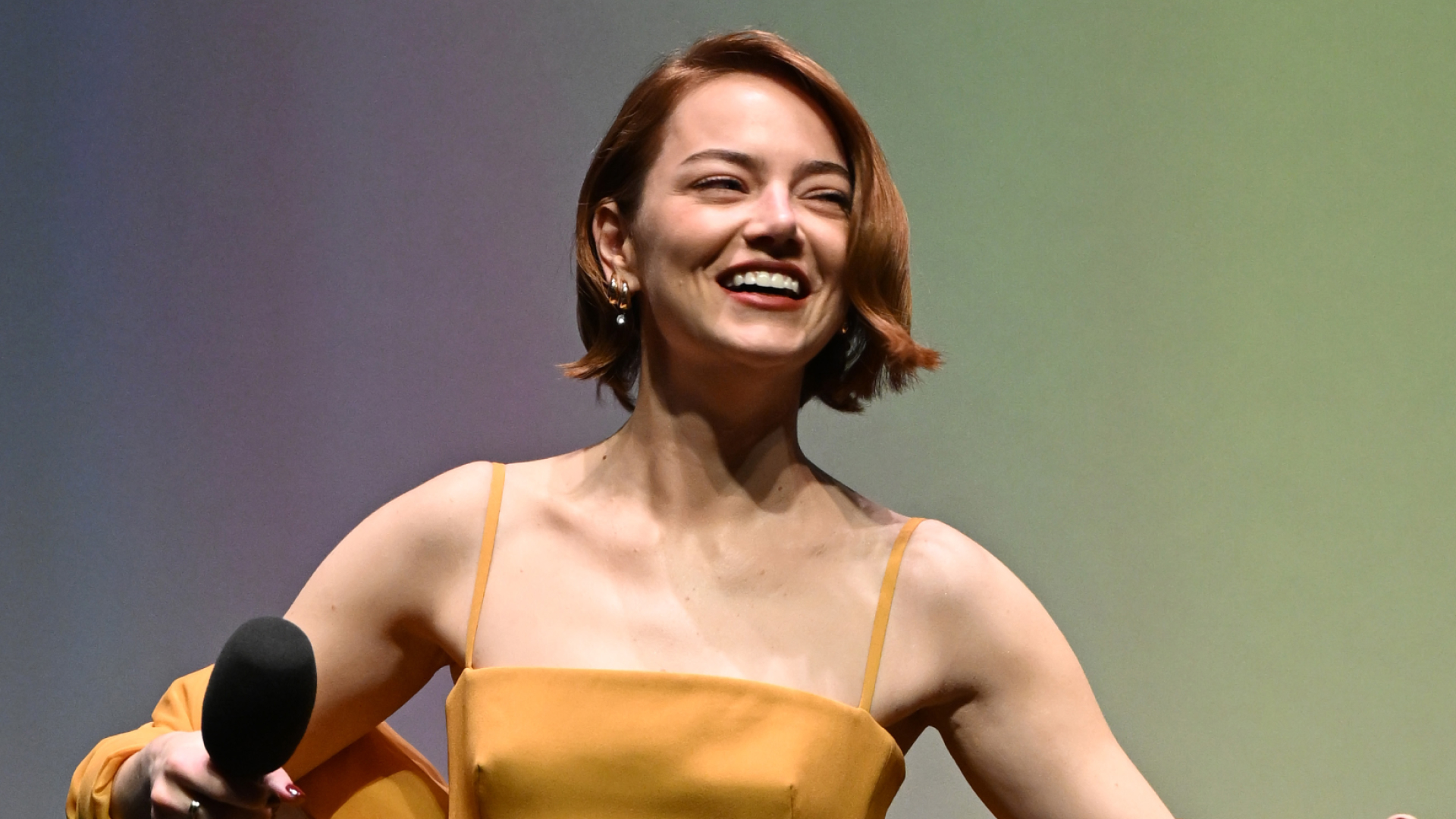 Emma Stone wearing Louis Vuitton custom gown in Showgirl Orange