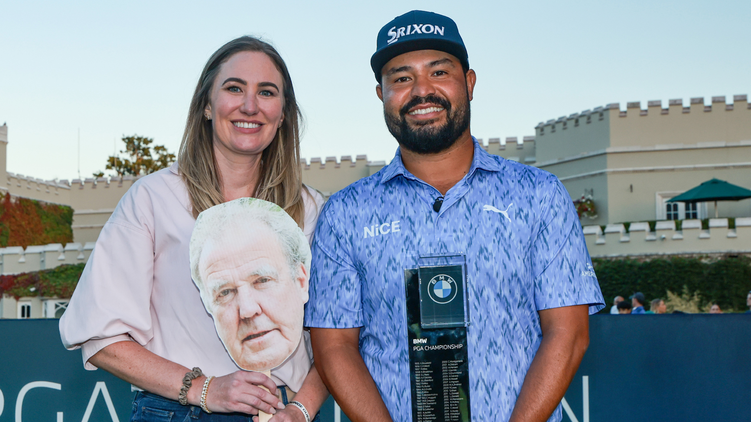 JJ Spaun with his wife, Melody, with the BMW PGA Championship trophy and a mask of Jeremy Clarkson