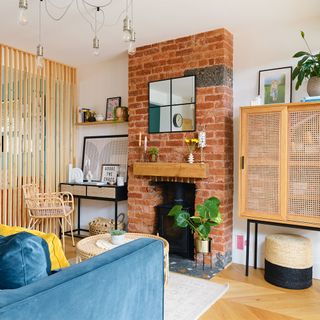 open plan living room with brick chimneybreast and room divider