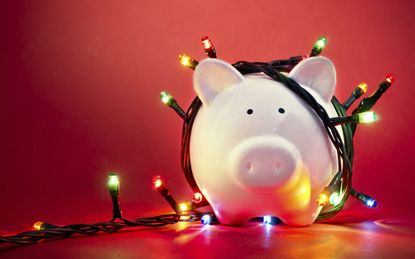 Piggy bank wrapped in Christmas string lights