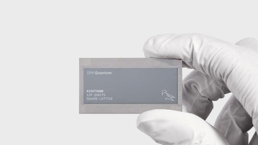 An IBM Quantum Nighthawk chip held by a gloved hand. 