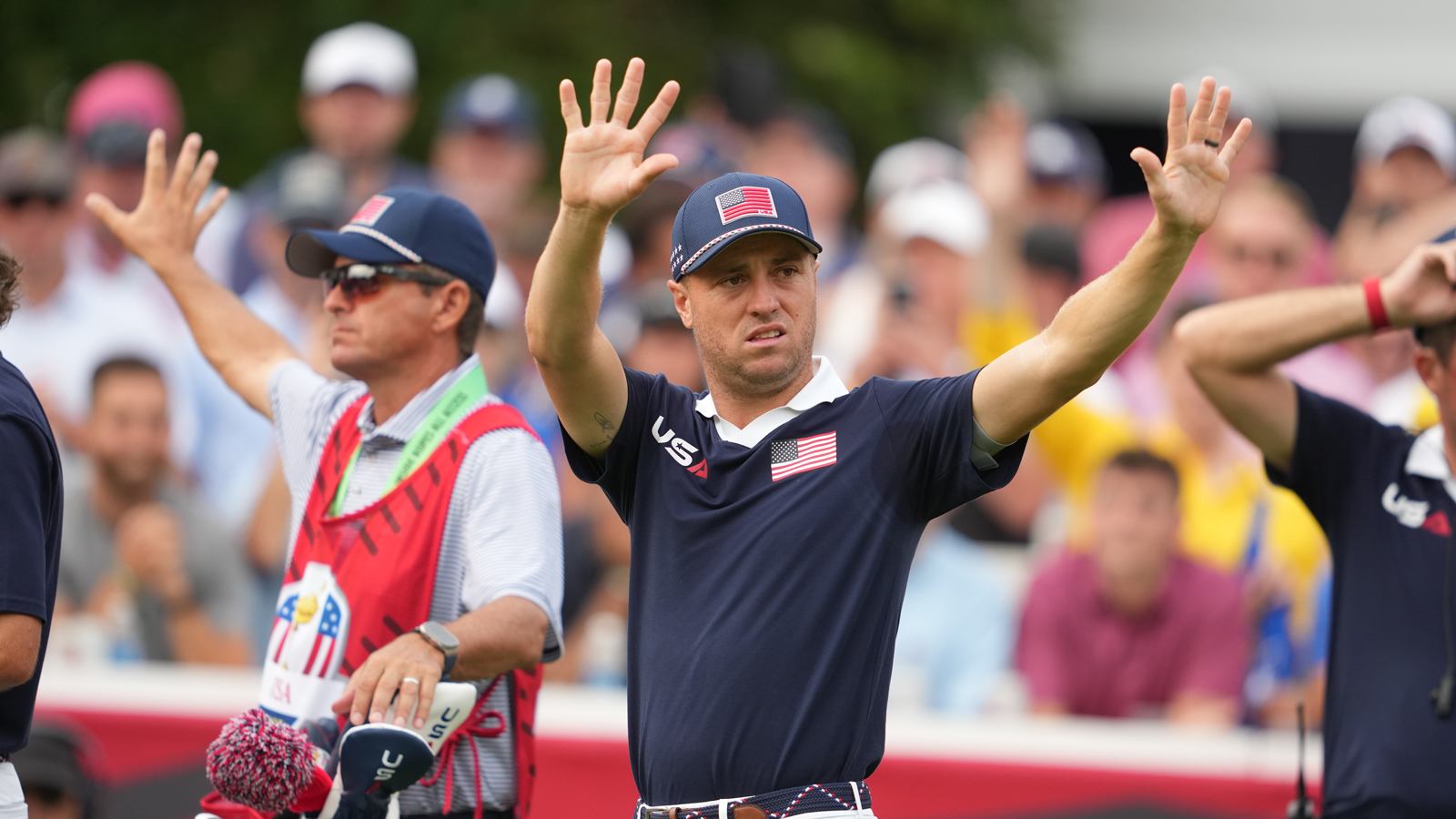 Justin Thomas raises his hands to quieten fans during the Ryder Cup