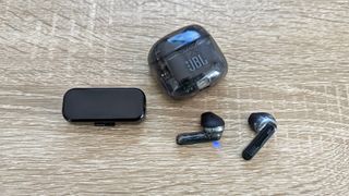 JBL Tune Flex true wireless earbuds outside of their case with small box and charging case