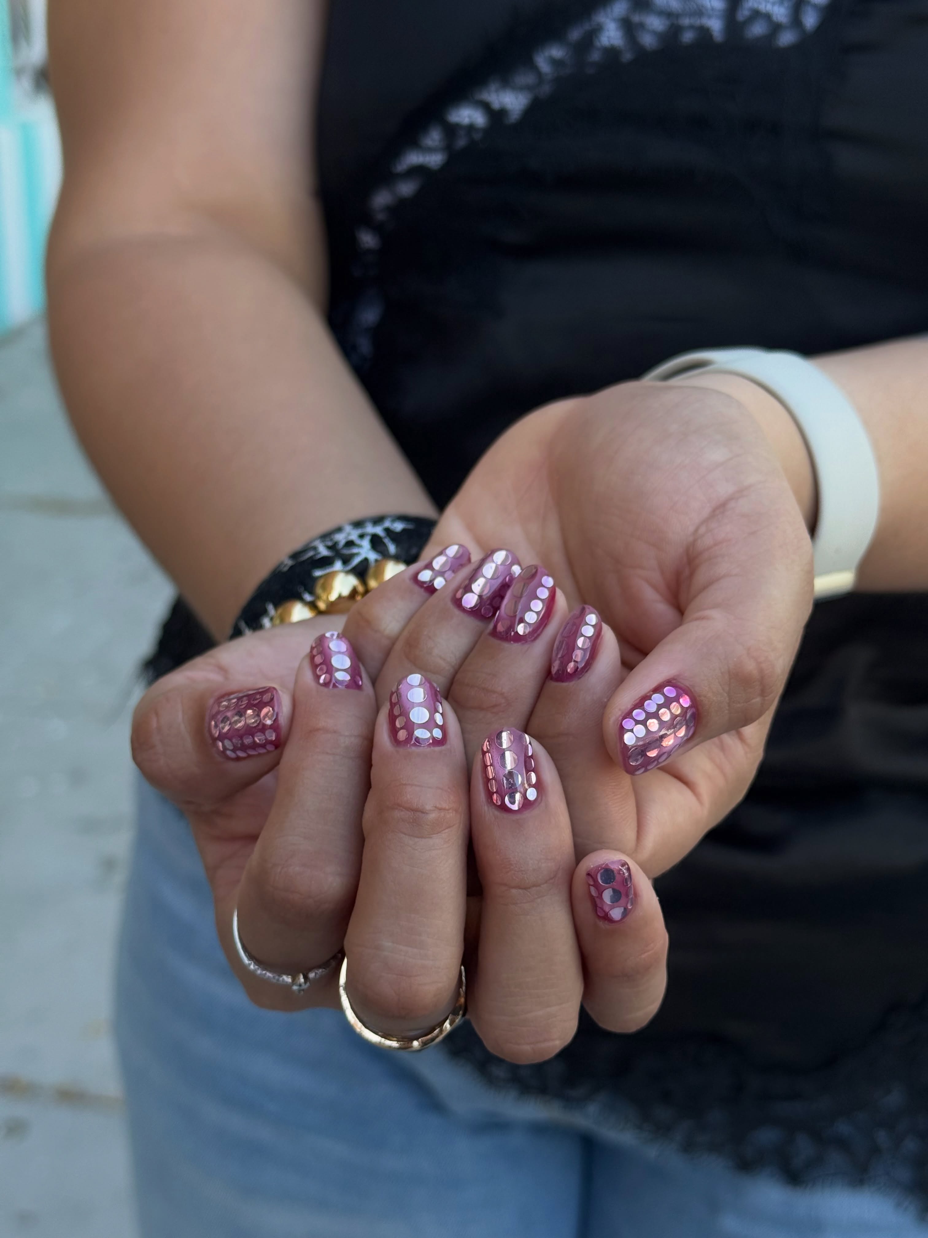 short pink nails covered with rows of iridescent pink and silver sequins