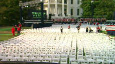 White House lawn with hundreds of chairs pushed side by side.
