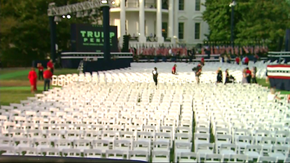 White House lawn with hundreds of chairs pushed side by side.