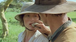 Robert Redford wipes Meryl Streep's mouth in an African savannah in Out of Africa