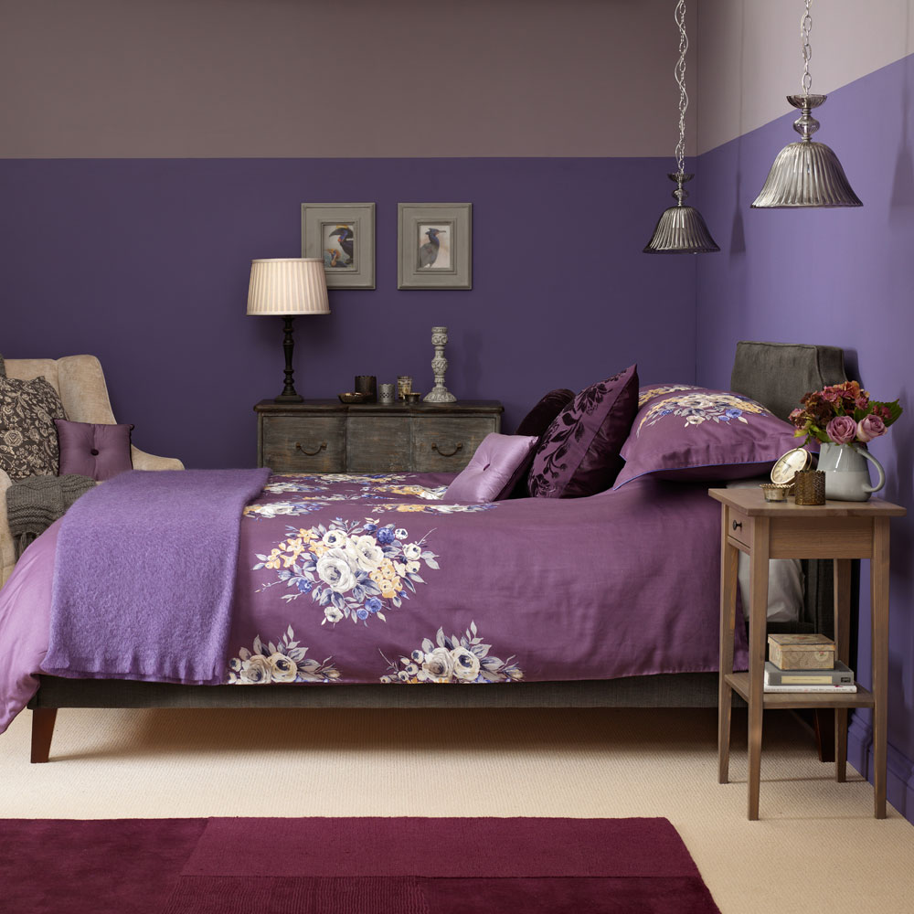 bedroom with purple wall and bed with purple bedding