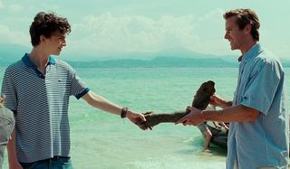 Call Me By Your Name Timothee Chalamet Armie Hammer shaking hands on the beach