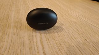 Huawei FreeBuds 6i opladningsetui på et bord