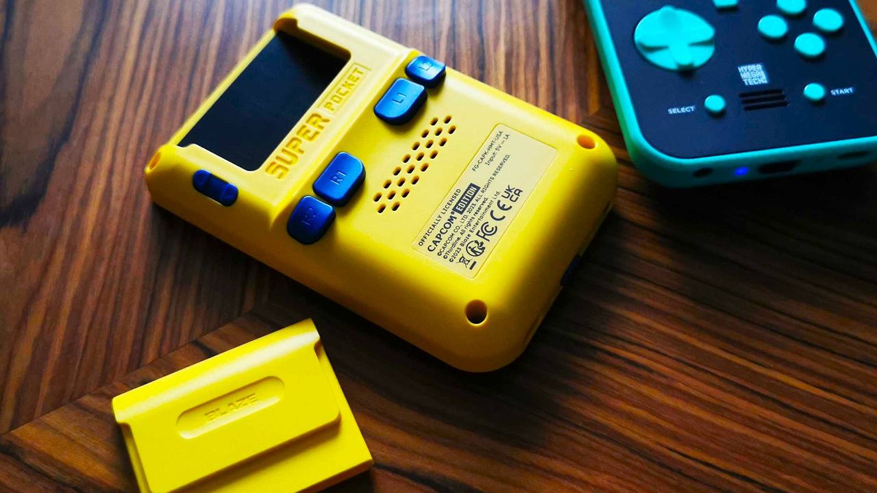 Back view of Capcom Super Pocket handheld on woodgrain table