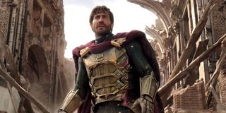 Spider-Man: Far From Home Mysterio, unmasked, stands in the ruins of an ongoing fight