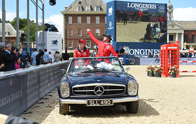 British showjumpers Ben Maher and Emily Moffitt wave to the home crowd during the parade of competitors