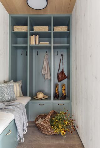 Small entryway with blue built in storage