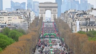 Aerial view of start of Paris Marathon 2023 on the Champs-Elysees with the Arc de Triomphe in the background