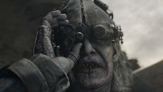 Dr Gideon adjusts his helmet and goggles in Resident Evil Requiem