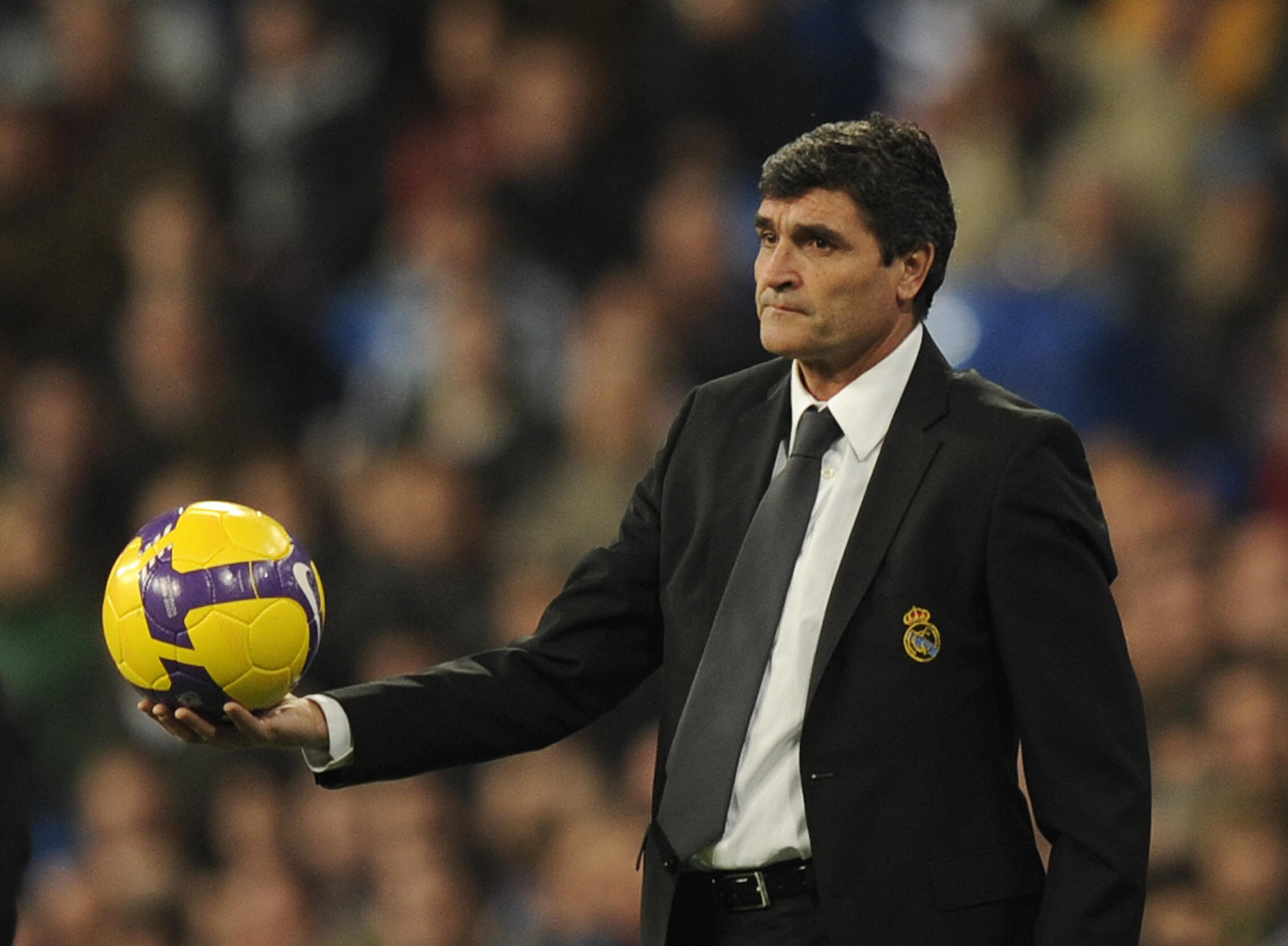 Real Madrid coach Juande Ramos holds the ball during a La Liga game against Valencia in December 2008.