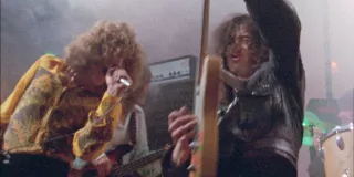 a still from the documentary becoming led zeppelin of the band performing live on stage