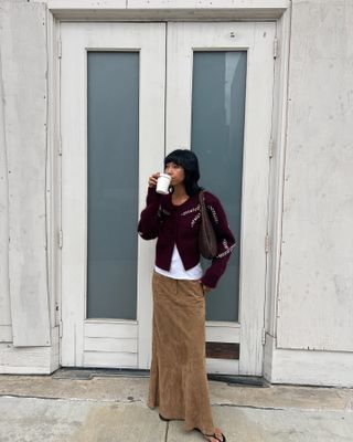 Fashion influencer Stephanie Arant wearing the burgundy color trend with brown suede.