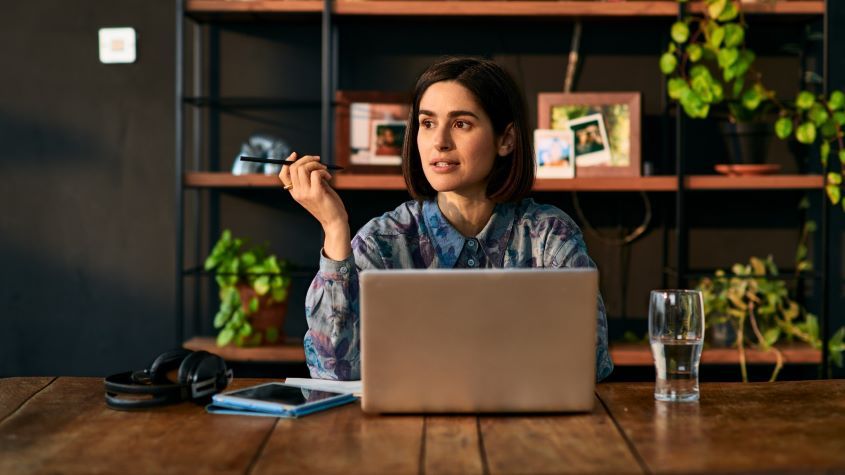 Woman sitting at desk using laptop