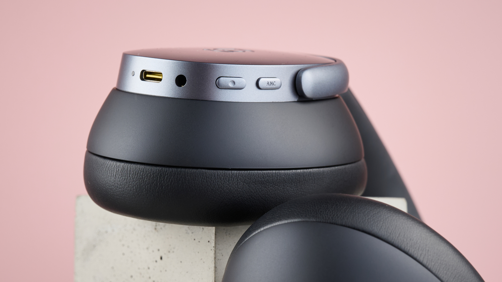 Baseus Inspire XH1 headphones against a pink background