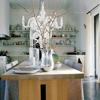 dining area with white wall and dining table with chair