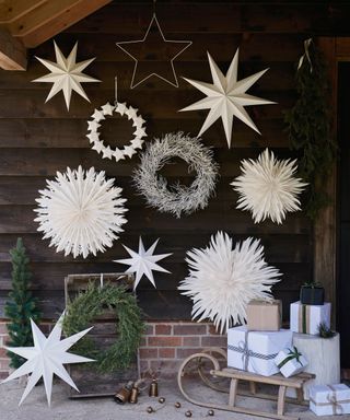 Oudoor Christmas decorations featuring display of large paper snowflakes and stars