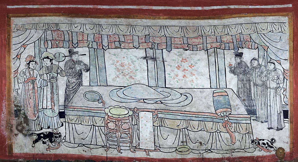 On the north wall of a 1,000-year-old tomb found recently in Datong City, in northern China, a mural shows shows a cat, dog and attendants in a bedroom with an empty bed. Exactly who occupied the tomb is a mystery -- no human remains were found.