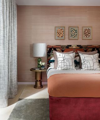 Pink bedroom with pink textured wall and coral bedding