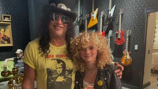 Slash (left) with Grace Bowers, with guitars in the background